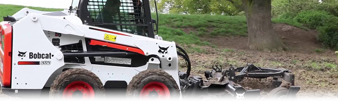 2017 Bobcat S550 parked next to a tree